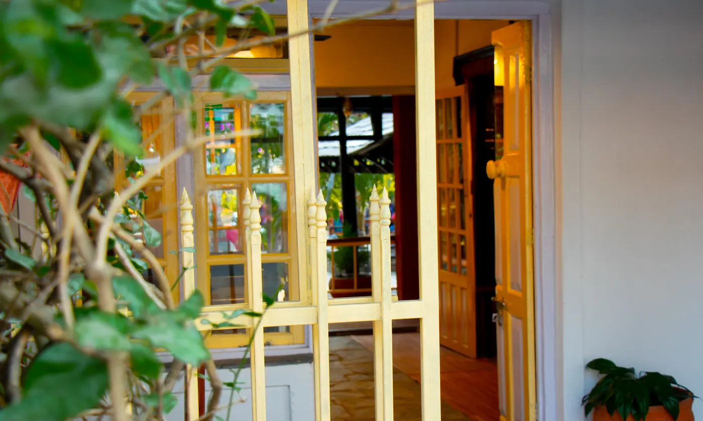 An open gate leading into a welcoming property